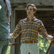 An entitled man in a plaid button-down shirt and khaki short harangues Eugene and Stephanie, who's heads are cut off by the framing of this image.